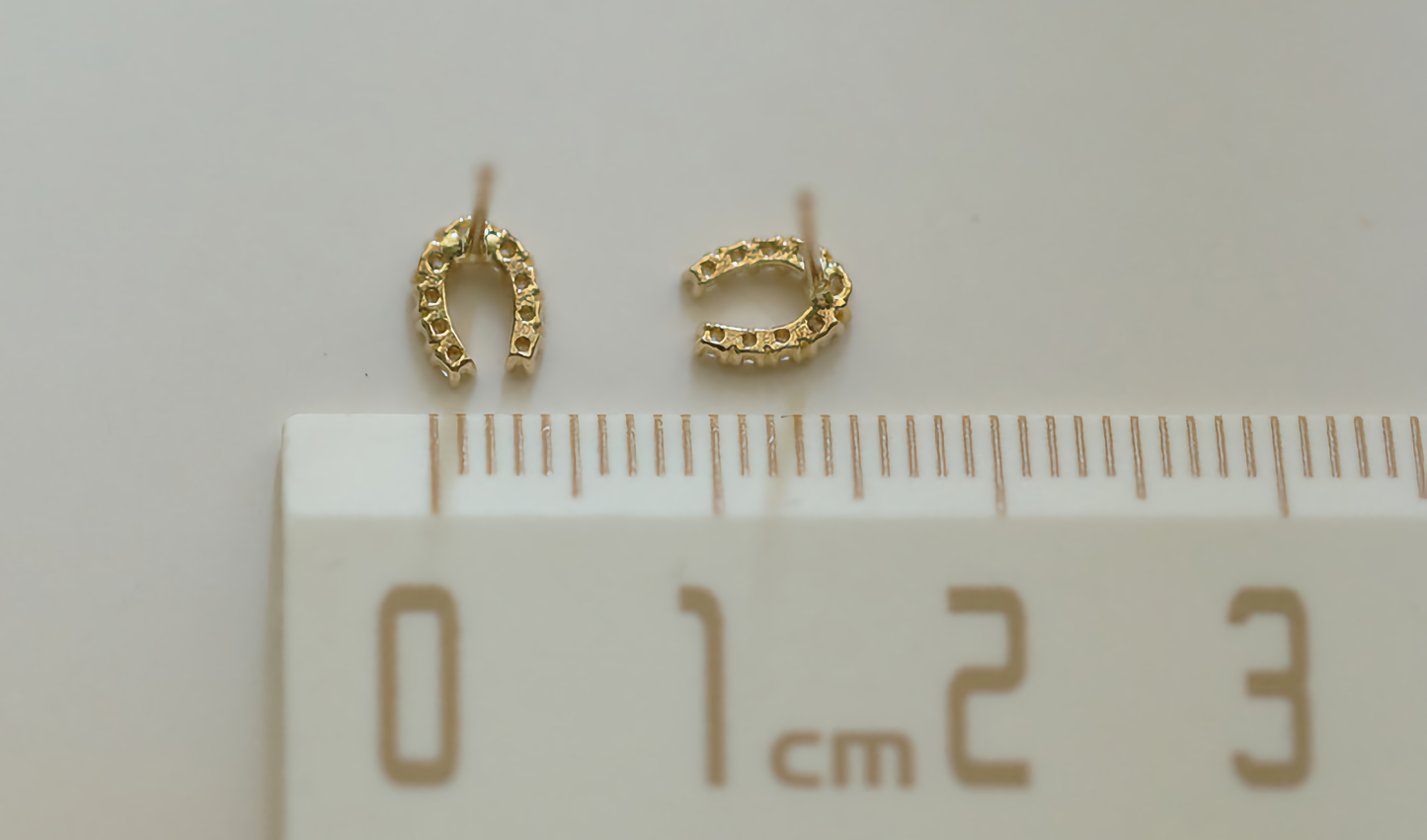 A pair of 9ct solid gold horseshoe earrings, delicately crafted to serve as both a fashionable accessory and a lucky charm. Measuring 5mm dainty size.