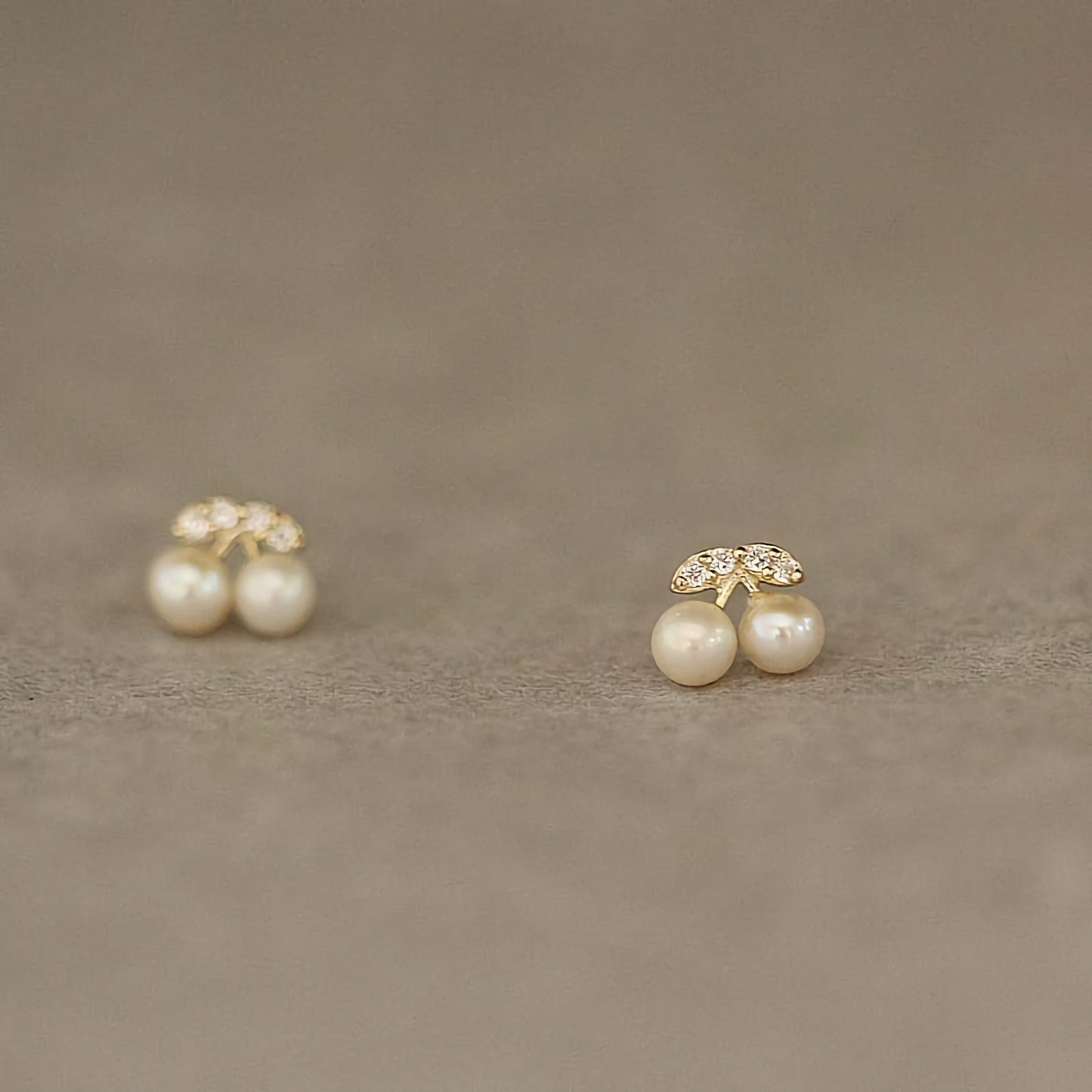 A pair of 9ct solid gold cherry earrings featuring pearls, exemplifying both fun and sophistication.