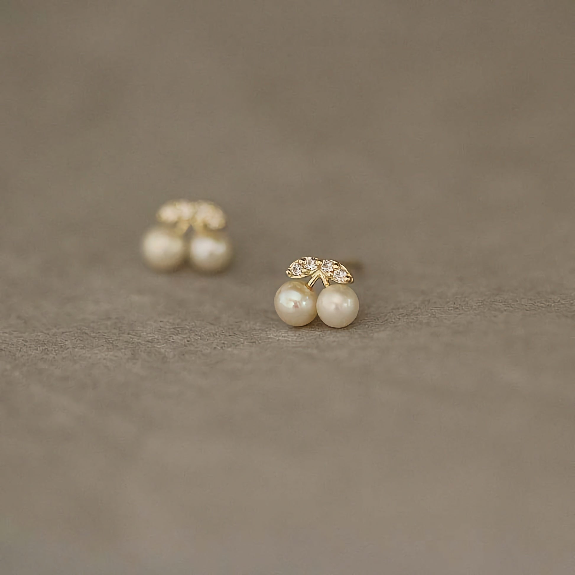 Detail-oriented 9ct solid gold cherry studs with beautiful pearl centers, perfect for a playful yet elegant look.
