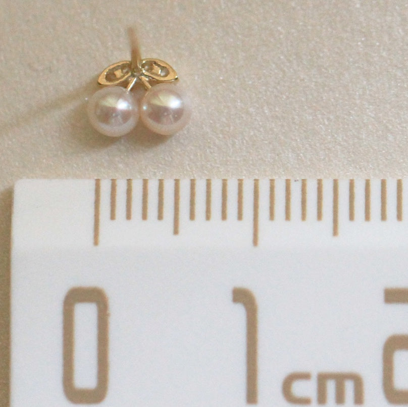 Artistic image of 9ct solid gold cherry studs, where pearls replace the fruit, demonstrating intricate craftsmanship, measuring 6mm in width